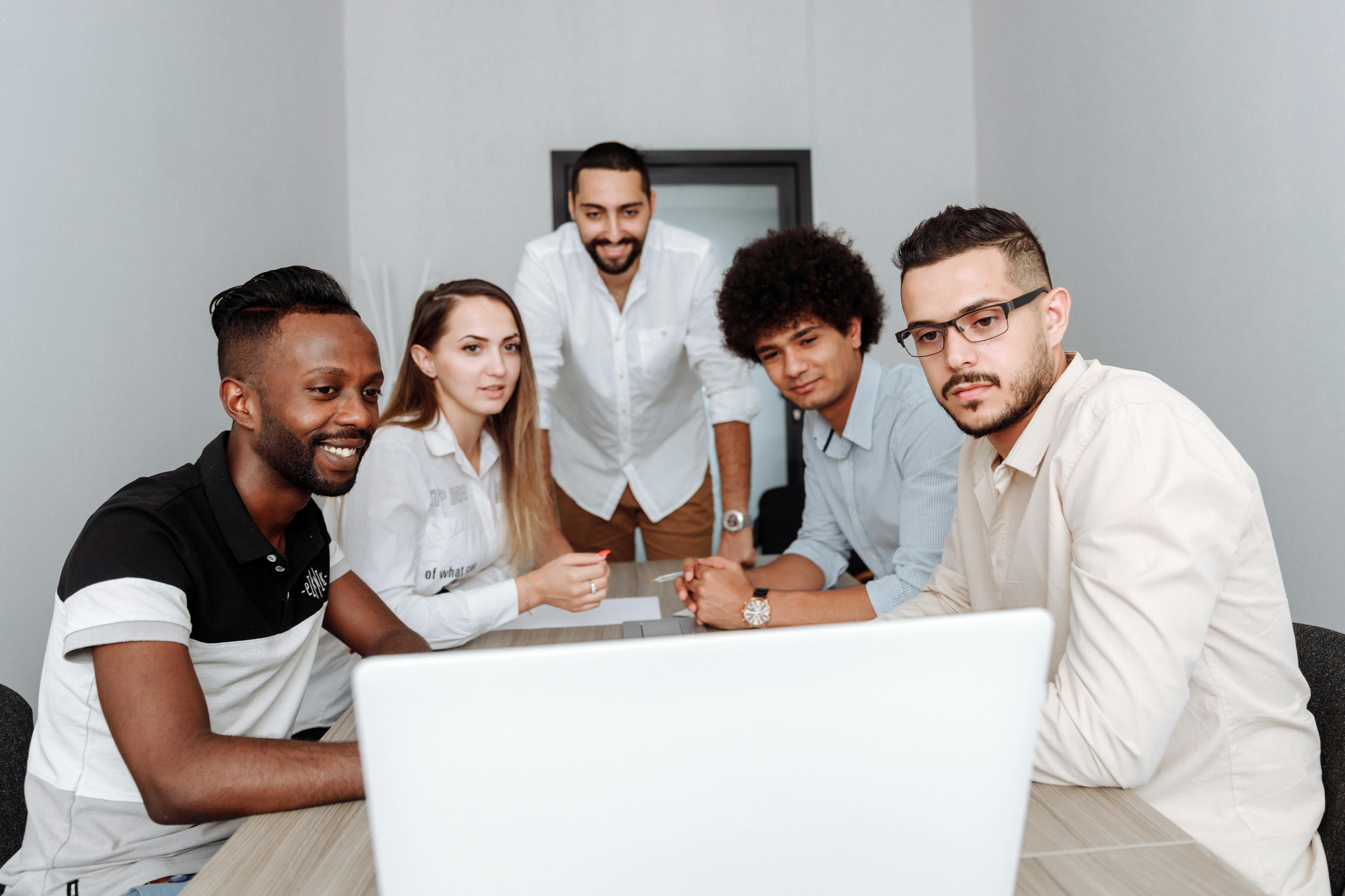 Team collaborating around a laptop